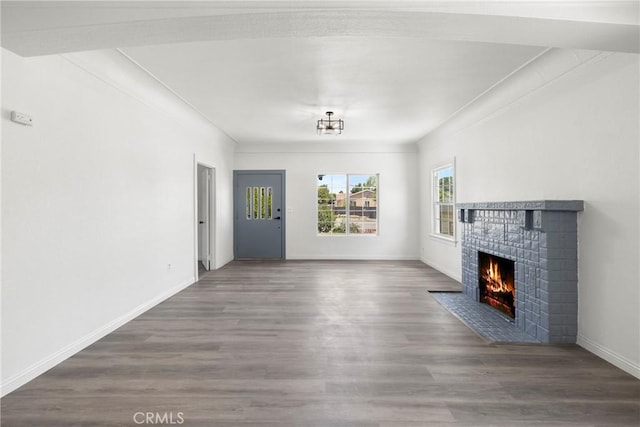 747 W 9th St, San Bernardino, CA 92410 - unfurnished living room featuring a brick fireplace, wood finished floors, and baseboards