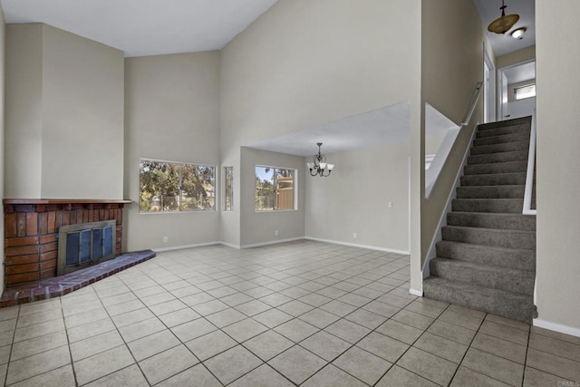 1561 Parkland Way, San Diego, CA 92114 - unfurnished living room with tile patterned floors, a chandelier, stairs, a towering ceiling, and a fireplace