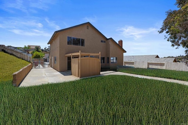 1561 Parkland Way, San Diego, CA 92114 - rear view of property featuring stucco siding, a fenced backyard, a patio area, a gate, and a chimney