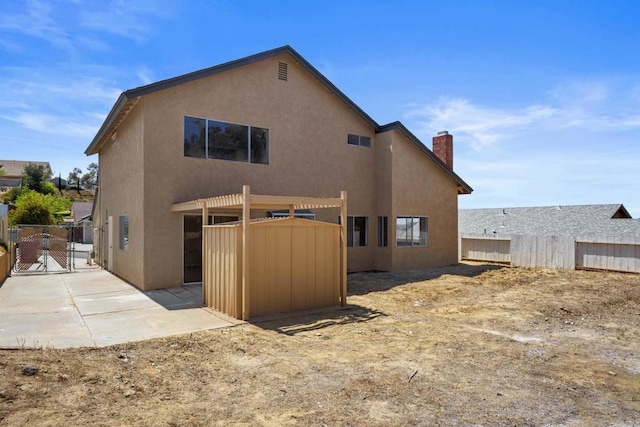 1561 Parkland Way, San Diego, CA 92114 - rear view of house featuring a gate, stucco siding, a fenced backyard, and a chimney