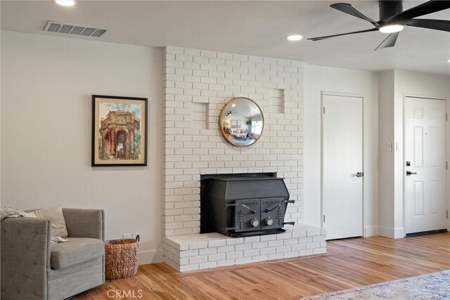 1105 Glenwood Ave, Chico, CA 95926 - living room featuring a wood stove, a ceiling fan, wood finished floors, baseboards, and recessed lighting