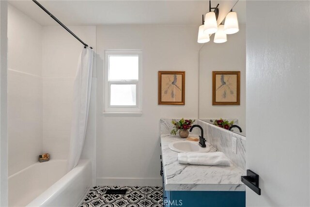 1105 Glenwood Ave, Chico, CA 95926 - bathroom with tile patterned floors, shower / bath combination with curtain, vanity, baseboards, and a chandelier