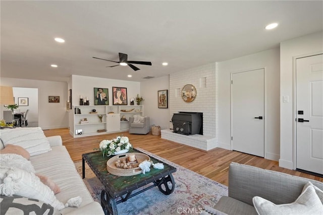 1105 Glenwood Ave, Chico, CA 95926 - living room with a wood stove, ceiling fan, light wood-type flooring, recessed lighting, and baseboards