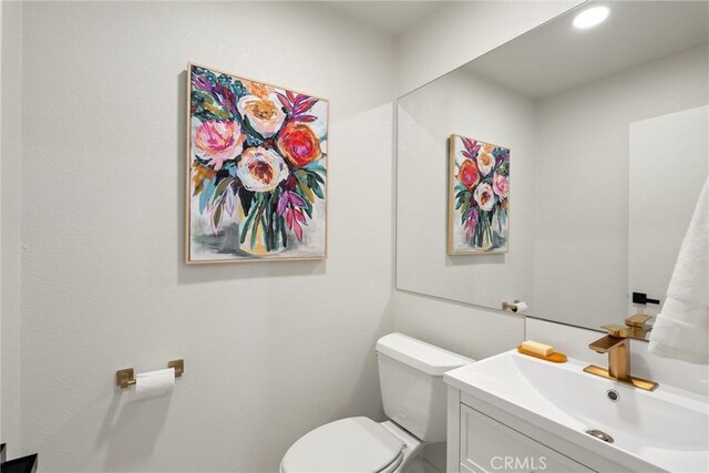 1105 Glenwood Ave, Chico, CA 95926 - bathroom featuring toilet, vanity, and recessed lighting