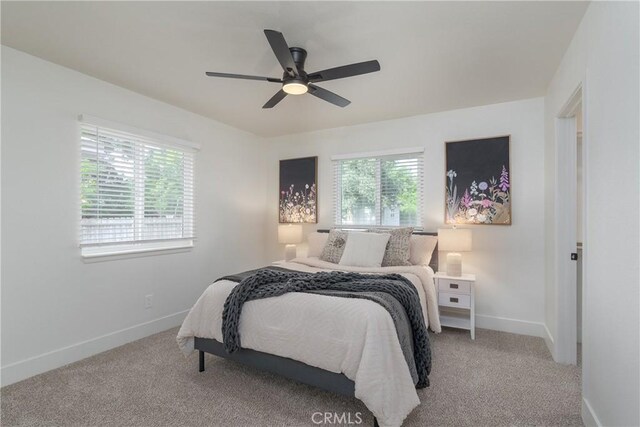 1105 Glenwood Ave, Chico, CA 95926 - bedroom with multiple windows, baseboards, light carpet, and a ceiling fan