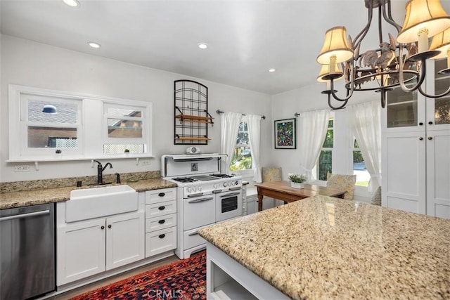 31462 La Matanza St, San Juan Capistrano, CA 92675 - kitchen with dishwasher, double oven range, a sink, a chandelier, and light stone countertops