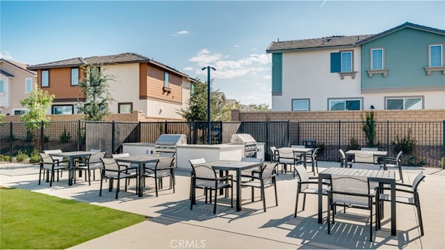 30025 Adrift Ln, Menifee, CA 92584 - view of patio featuring exterior kitchen, fence, outdoor dining space, and area for grilling