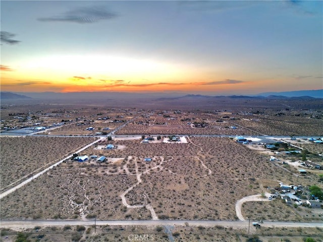 177 Cherokee Trl, Yucca Valley, CA 92284 - aerial view of sparsely populated area with a mountain backdrop and a desert landscape