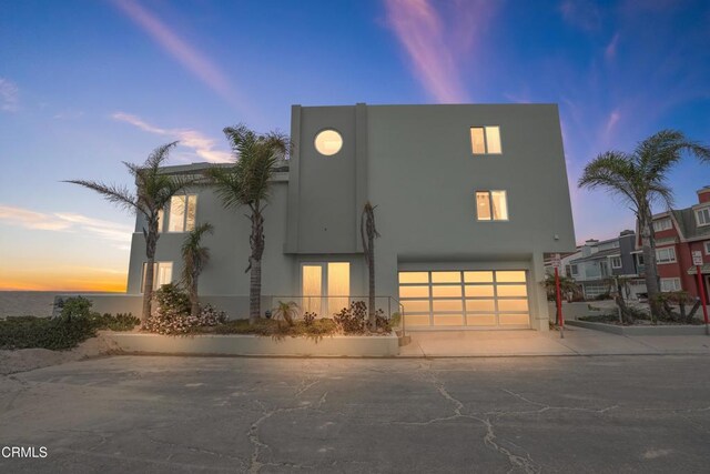 3903 Ocean Dr, Oxnard, CA 93035 - view of front facade featuring concrete driveway, a garage, and stucco siding