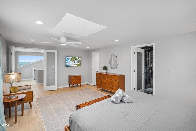 3903 Ocean Dr, Oxnard, CA 93035 - bedroom featuring a skylight, light wood-style flooring, recessed lighting, multiple windows, and a ceiling fan