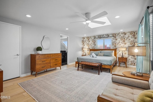 3903 Ocean Dr, Oxnard, CA 93035 - bedroom featuring a skylight, baseboards, wood finished floors, ceiling fan, and recessed lighting