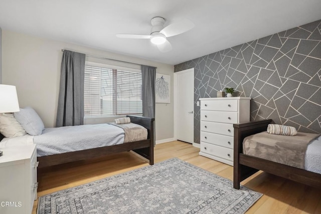 3903 Ocean Dr, Oxnard, CA 93035 - bedroom with an accent wall, wood finished floors, a ceiling fan, and baseboards