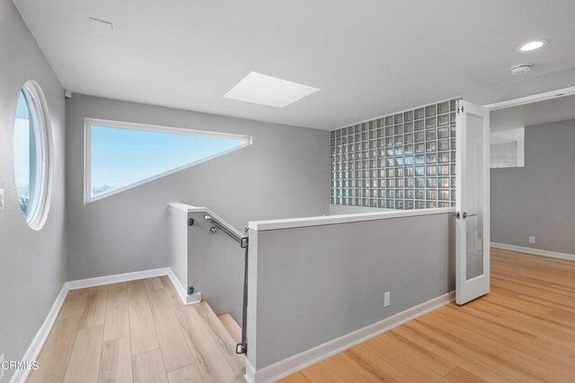 3903 Ocean Dr, Oxnard, CA 93035 - stairway with a skylight, wood finished floors, and recessed lighting