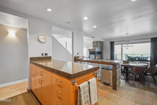 3903 Ocean Dr, Oxnard, CA 93035 - kitchen featuring a peninsula, recessed lighting, hanging light fixtures, and open floor plan