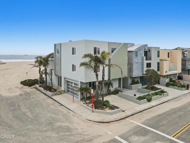 3903 Ocean Dr, Oxnard, CA 93035 - view of property with a garage, view of water and beach, and driveway