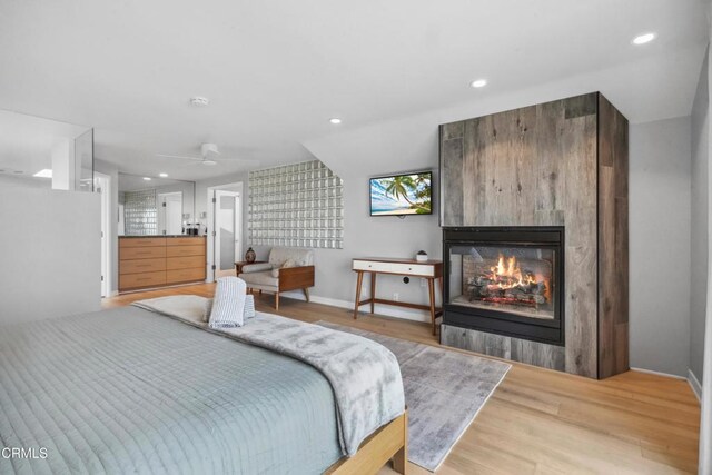 3903 Ocean Dr, Oxnard, CA 93035 - bedroom featuring light wood-type flooring, a multi sided fireplace, and recessed lighting
