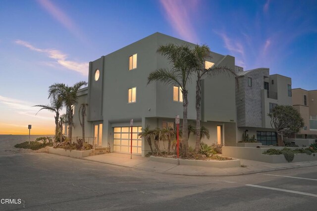 3903 Ocean Dr, Oxnard, CA 93035 - property at dusk featuring an attached garage and driveway