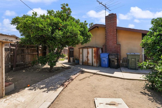 1520 Flanagan St, Pomona, CA 91766 - back of property with stucco siding, fence, and a chimney