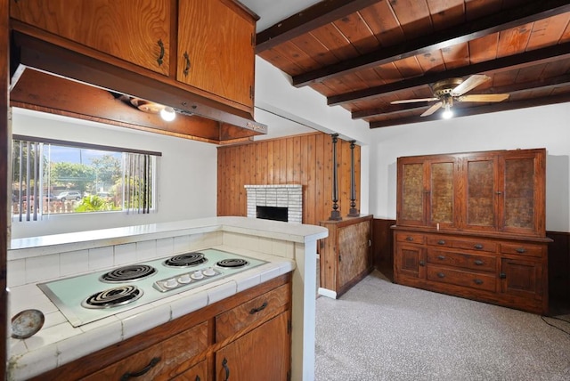 1520 Flanagan St, Pomona, CA 91766 - kitchen featuring tile counters, wooden walls, white electric cooktop, beam ceiling, and wood ceiling