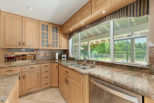 11616 E Las Posas Rd, Camarillo, CA 93012 - kitchen featuring stainless steel dishwasher, a sink, light stone countertops, light tile patterned floors, and glass insert cabinets