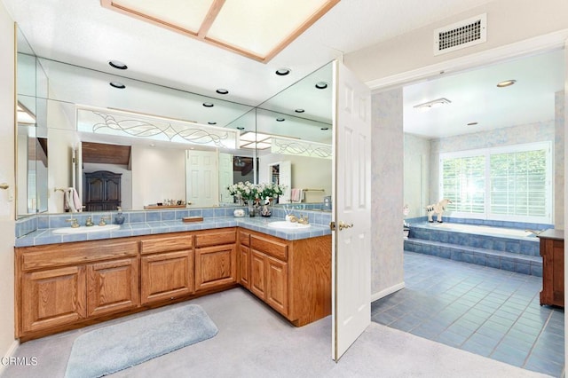 11616 E Las Posas Rd, Camarillo, CA 93012 - bathroom with a bath, double vanity, recessed lighting, and baseboards