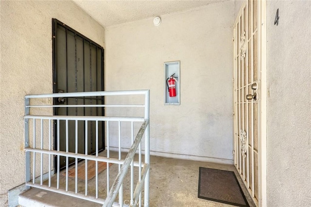 doorway to property featuring stucco siding