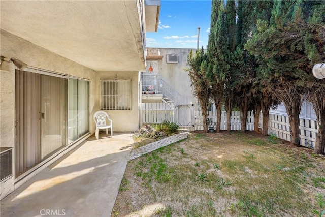 view of yard featuring fence and a patio