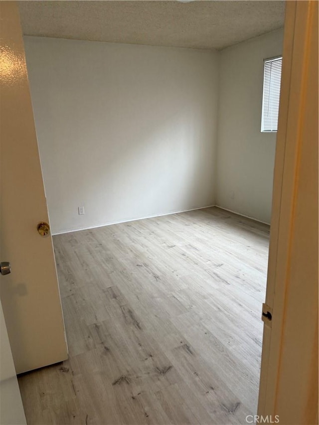 empty room with wood finished floors
