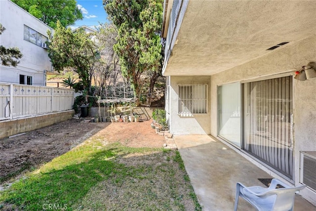view of yard with fence and a patio