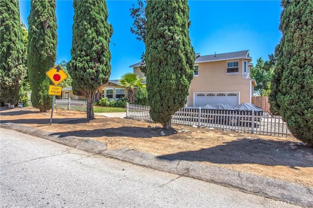 375 E County Line Rd, Calimesa, CA 92320 - obstructed view of property featuring an attached garage and a fenced front yard