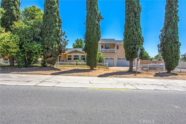 375 E County Line Rd, Calimesa, CA 92320 - view of front facade featuring an attached garage, driveway, and a fenced front yard