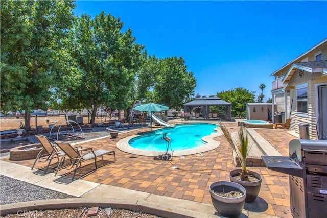 375 E County Line Rd, Calimesa, CA 92320 - view of pool with a gazebo, a water slide, a fire pit, a patio area, and a hot tub