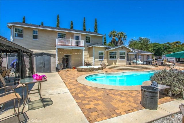 375 E County Line Rd, Calimesa, CA 92320 - view of pool featuring a gazebo, a patio, a hot tub, and a storage shed