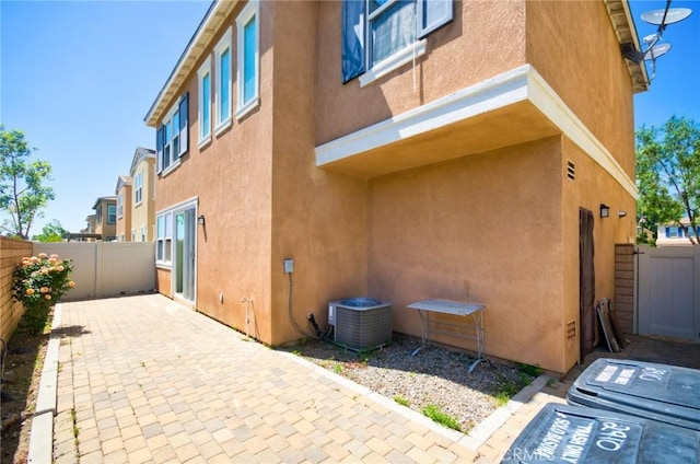 2910 E Via Terrano, Ontario, CA 91764 - view of property exterior featuring central air condition unit, stucco siding, a fenced backyard, and a patio area