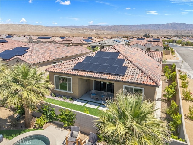 27 Medoc, Rancho Mirage, CA 92270 - back of property featuring a tile roof, stucco siding, a residential view, a patio area, and solar panels