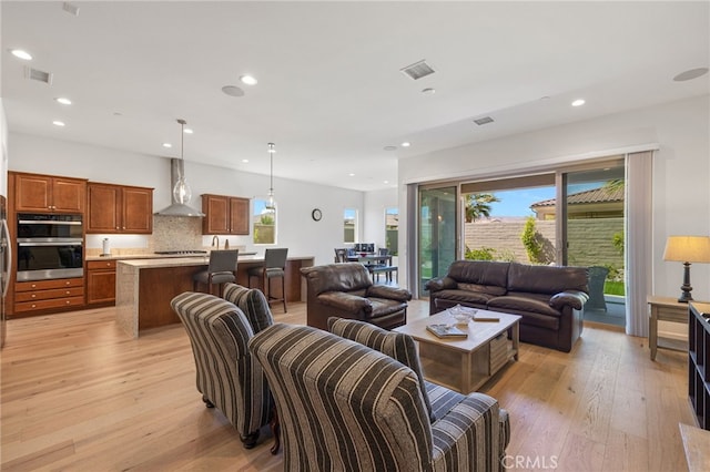 27 Medoc, Rancho Mirage, CA 92270 - living room featuring light wood-style flooring, healthy amount of natural light, and recessed lighting