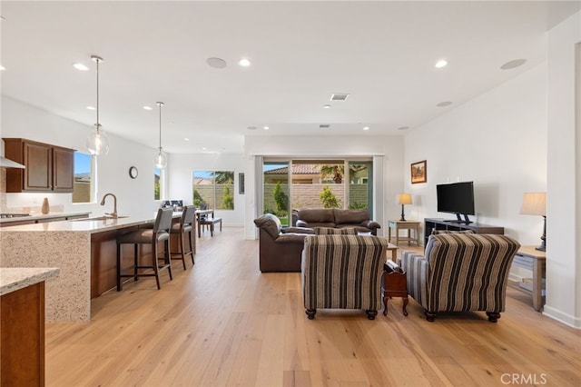 27 Medoc, Rancho Mirage, CA 92270 - living area featuring light wood-type flooring, recessed lighting, healthy amount of natural light, and baseboards