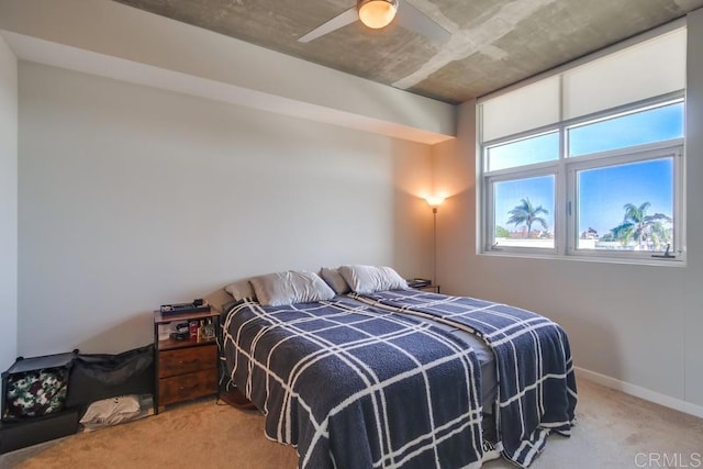 carpeted bedroom featuring ceiling fan and baseboards