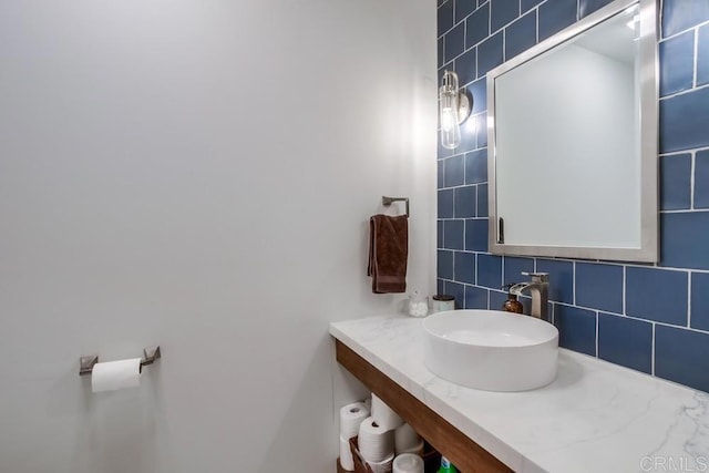 bathroom featuring decorative backsplash and vanity