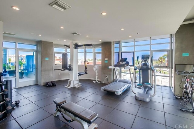 gym with expansive windows and recessed lighting