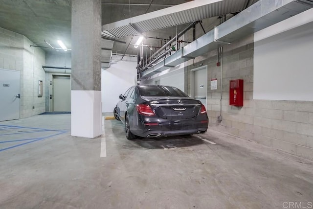 parking deck featuring concrete block wall