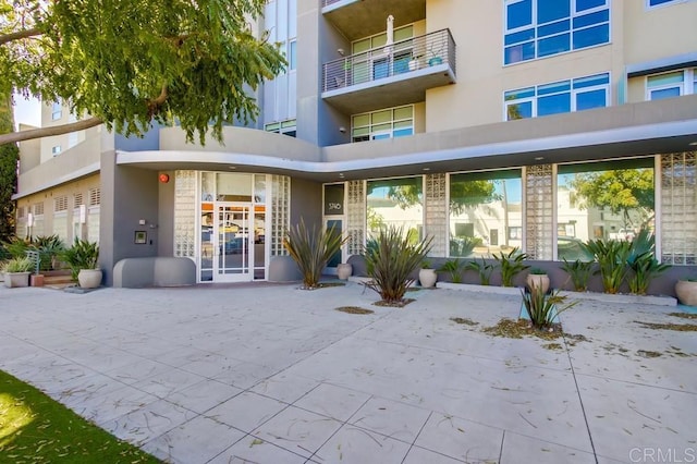 property entrance with stucco siding