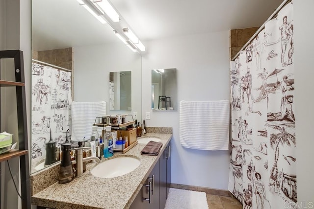 bathroom featuring vanity, baseboards, a shower with curtain, and tile patterned flooring
