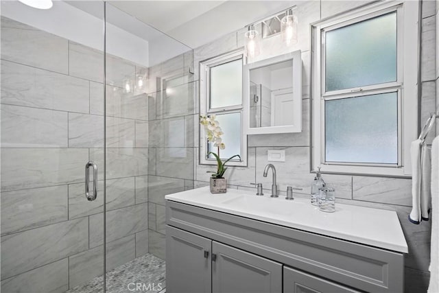 5616 Buffalo Ave, Valley Glen, CA 91401 - full bathroom featuring vanity, a shower stall, tile walls, and backsplash