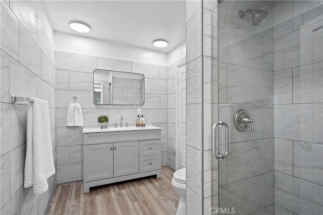 5616 Buffalo Ave, Valley Glen, CA 91401 - full bathroom with a stall shower, vanity, wood finished floors, and tile walls