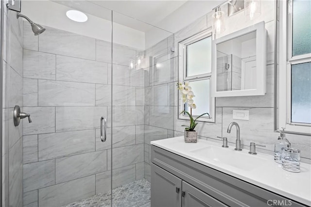 5616 Buffalo Ave, Valley Glen, CA 91401 - full bathroom featuring a shower stall, vanity, plenty of natural light, and decorative backsplash