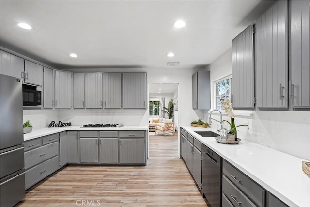 5616 Buffalo Ave, Valley Glen, CA 91401 - kitchen with gray cabinetry, appliances with stainless steel finishes, light wood finished floors, light countertops, and recessed lighting