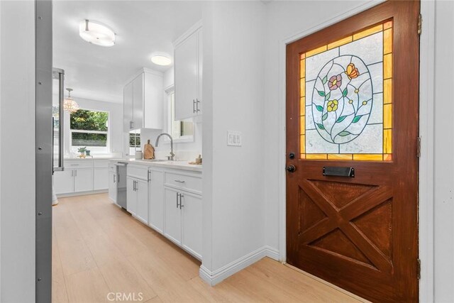 6454 Baird Ave, Reseda, CA 91335 - foyer featuring light wood finished floors and baseboards