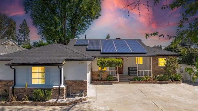 6454 Baird Ave, Reseda, CA 91335 - single story home with a porch, stone siding, solar panels, and a shingled roof