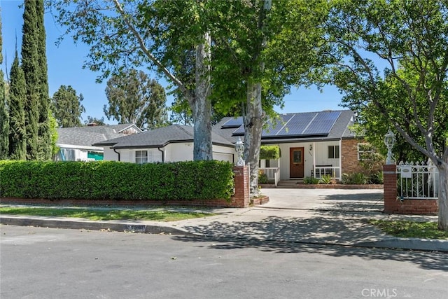 6454 Baird Ave, Reseda, CA 91335 - view of front facade with solar panels, driveway, and a porch